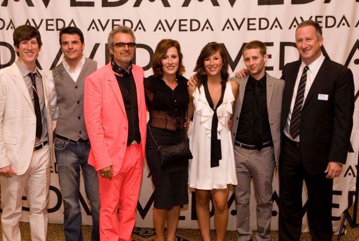 - Paris Parker Aveda Salons and Spas - Baton Rouge, New Orleans, Mandeville, LA A group of six people in formal attire pose in front of a step-and-repeat banner with the AVEDA logo, celebrating their visit to an Aveda Salon and Day Spa. - Paris Parker Aveda Salons and Spas - Baton Rouge, New Orleans, Mandeville, LA