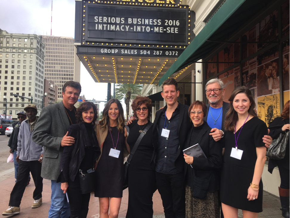 - Paris Parker Aveda Salons and Spas - Baton Rouge, New Orleans, Mandeville, LA A group of eight people stand and smile outside a theater with a marquee reading “Serious Business 2016 Intimacy-Into-Me-See,” looking as refreshed as if they’d just left a day spa or hair salon, in an urban setting. - Paris Parker Aveda Salons and Spas - Baton Rouge, New Orleans, Mandeville, LA