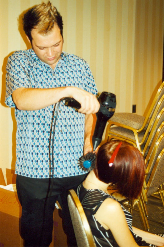 - Paris Parker Aveda Salons and Spas - Baton Rouge, New Orleans, Mandeville, LA A stylist gives a seated woman a blowout with a round brush in an Aveda Salon, the room featuring stacked chairs and striped wallpaper. - Paris Parker Aveda Salons and Spas - Baton Rouge, New Orleans, Mandeville, LA