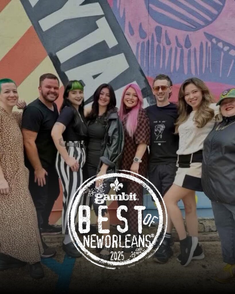 - Paris Parker Aveda Salons and Spas - Baton Rouge, New Orleans, Mandeville, LA A group of eight people stand in front of a colorful mural, showing off fresh haircuts. A Gambit Best of New Orleans 2025 logo is displayed at the bottom of the image. - Paris Parker Aveda Salons and Spas - Baton Rouge, New Orleans, Mandeville, LA
